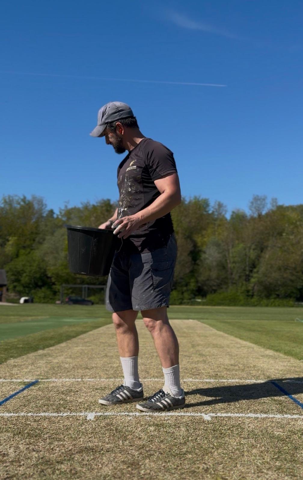 Joe Gatford preparing the cricket pitch
